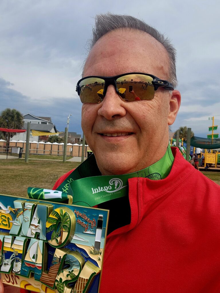 Brian Peters- prostate cancer survivor with half marathon medal