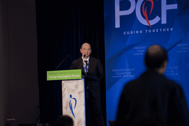 2025 Young Investigator Forum Photo- YI standing at podium smiling