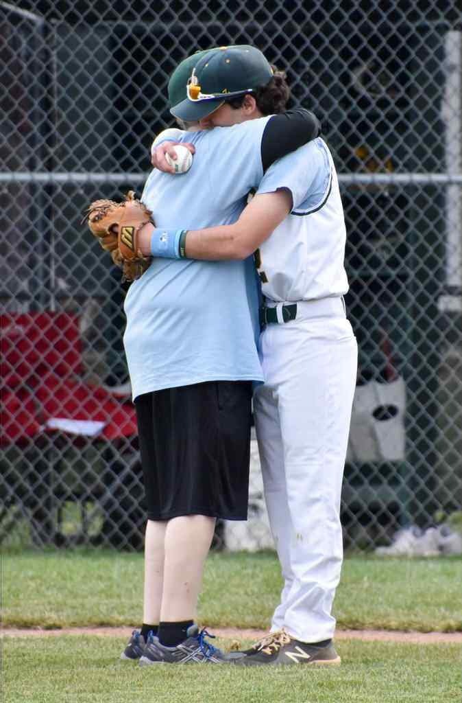Derek hugging his father, Sal on the baseball field